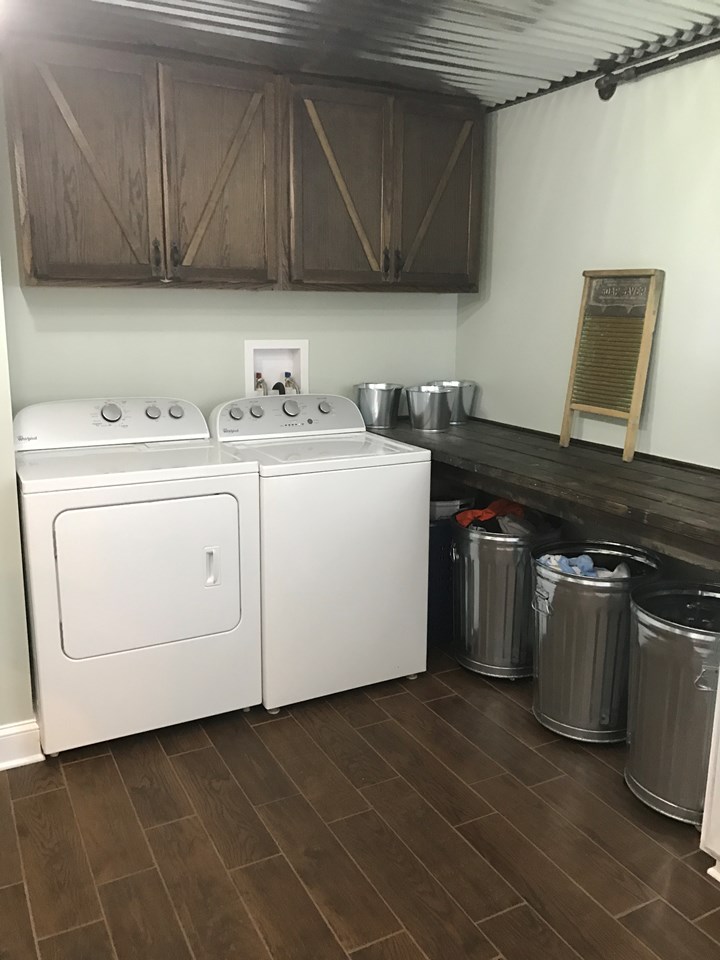 rustic laundry room rustic laundry room features custom barn door finishes.